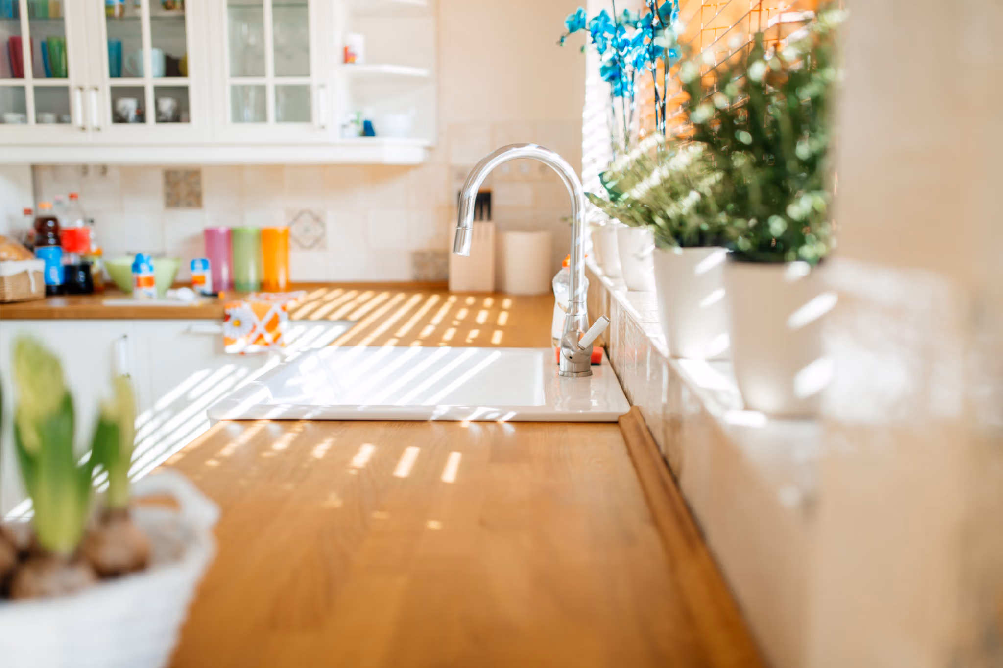 Modern white kitchen sink with morning sun rays